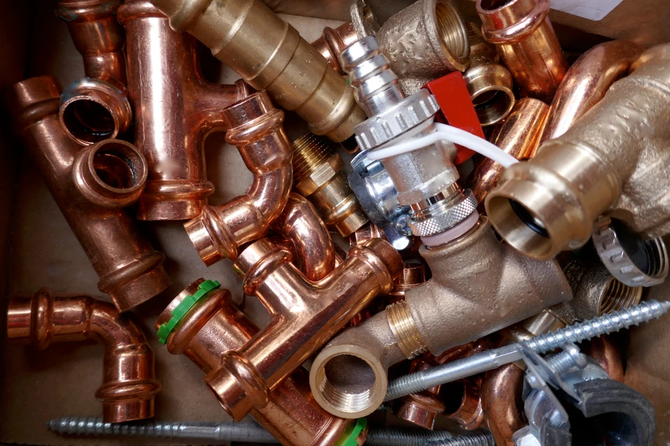 Vue détaillée de la plomberie et du câblage internes d'une chaudière à gaz moderne, installée sur un mur blanc propre